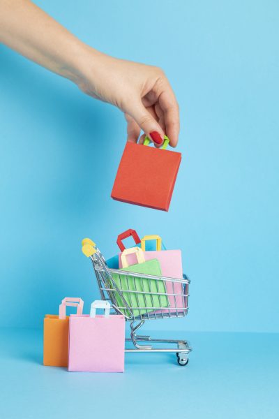 Shopping basket full of paper bags. Sesonal sale, online deals, discounts, promotions idea Shopping basket full of paper bags. Sesonal sale, online deals, discounts, promotion, shopping addiction concept